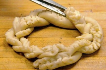Dominic DeFabo, 10, clips woven dough with scissors to create thorns in a Crown of Thorns in the kitchen of Rizzo's Malabar Inn for the annual St. Joseph's Day display.
